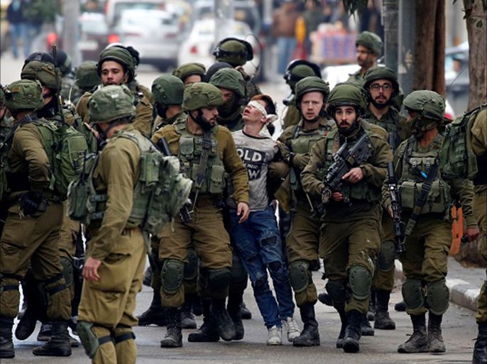 Protest against US decision to recognize Jerusalem as Israel's capital HEBRON, WEST BANK - DECEMBER 7 : Israeli forces detain Palestinian Fevzi El-Junidi, 14-year-old, following clashes after protests against a decision by US President Donald Trump to recognize Jerusalem as the capital of Israel, in the West Bank city Hebron, 07 December 2017. (Photo by Wisam Hashlamoun/Anadolu Agency/Getty Images)