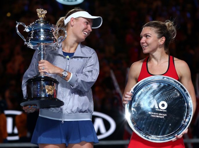 MELBOURNE, AUSTRALIA - JANUARY 27: Caroline Wozniacki (L) of Denmark poses for a photo with the Daphne Akhurst Memorial Cup after winning the women's singles final against Simona Halep of Romania, posing with the runners-up trophy on day 13 of the 2018 Australian Open at Melbourne Park on January 27, 2018 in Melbourne, Australia. (Photo by Clive Brunskill/Getty Images)