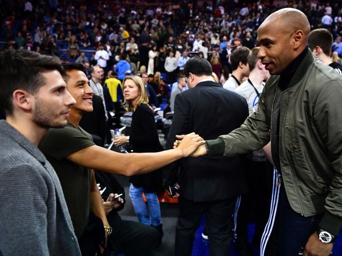 LONDON, ENGLAND - JANUARY 12: Former footballer, Thierry Henry (R) speaks to Arsenal player Alexis Sanchez (L) looks on during the NBA match between Indiana Pacers and Denver Nuggets at the O2 Arena on January 12, 2017 in London, England. (Photo by Dan Mullan/Getty Images)