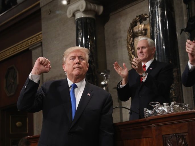 U.S. President Donald J. Trump (L) gestures at the podium in front of U.S. Vice President Mike Pence (L) and Speaker of the House U.S. Rep. Paul Ryan (R-WI) during his first State of the Union address to a joint session of Congress inside the House Chamber on Capitol Hill in Washington, U.S., January 30, 2018. REUTERS/Win McNamee/Pool