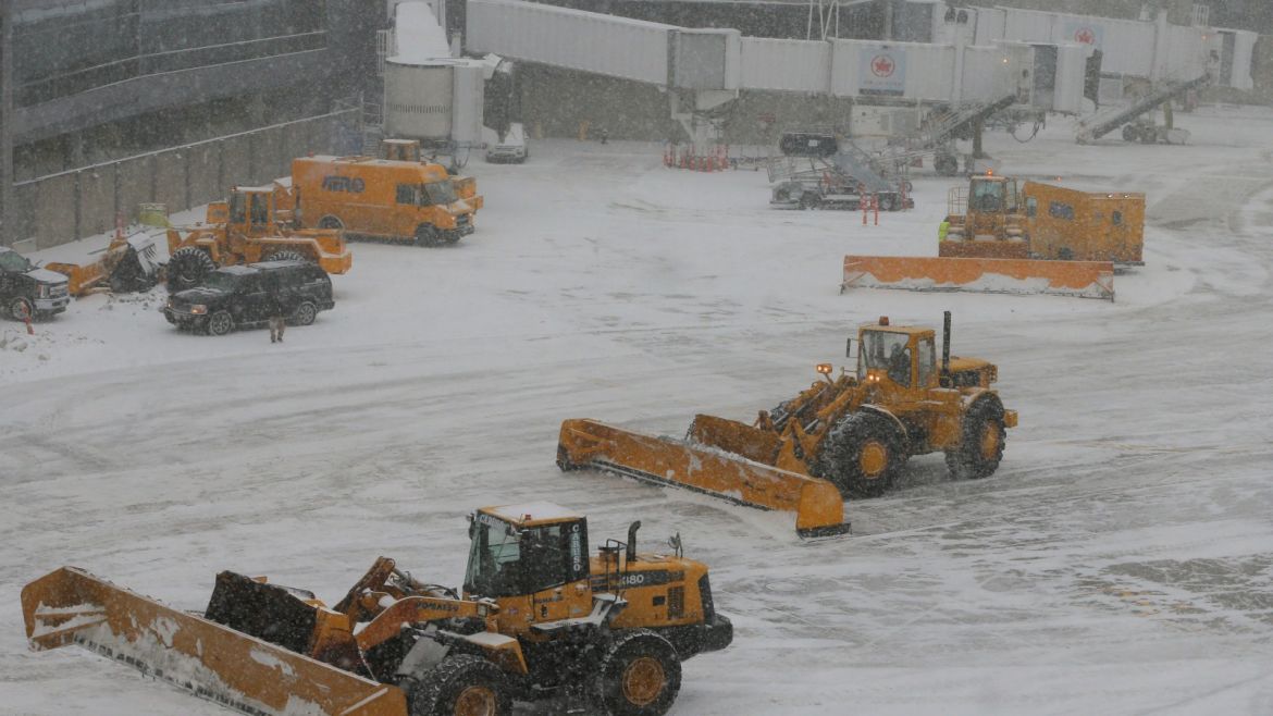 Crews clear snow from around the gates at Logan International Airport during a winter snow storm in Boston, Massachusetts, U.S., January 4, 2018.  REUTERS/Brian Snyder