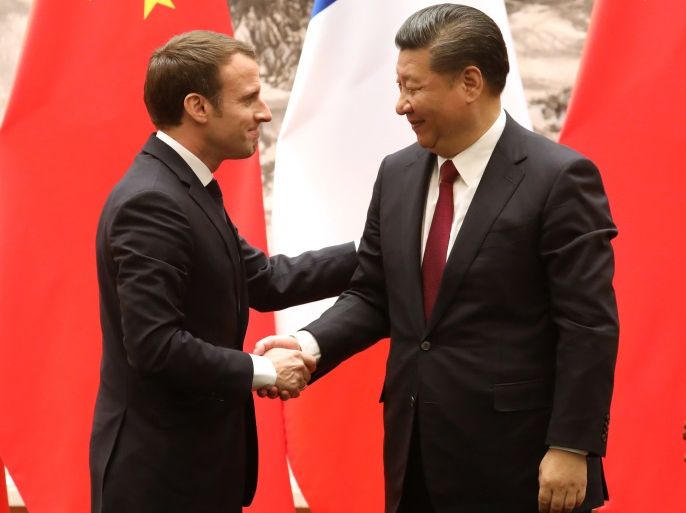 French President Emmanuel Macron (L) and Chinese President Xi Jinping shake hands during a press conference in Beijing, China, January 9, 2018. REUTERS/Ludovic Marin/Pool