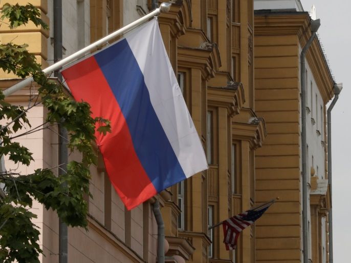 A Russian flag flies in front of the U.S. embassy building in Moscow, Russia, July 28, 2017. REUTERS/Tatyana Makeyeva