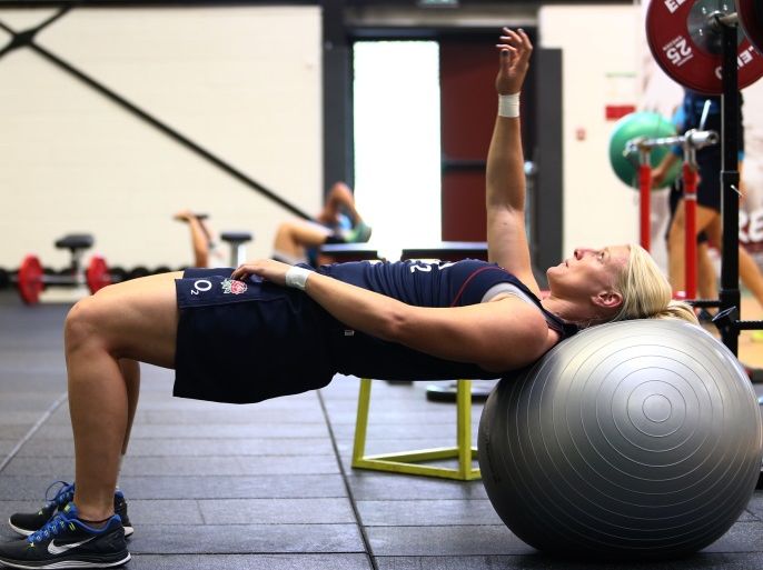 PARIS, FRANCE - AUGUST 15: England strength and conditioning coach Stuart Pickering (L) looks on as Tamara Taylor (R) warms up in the gym ahead of an England Training Session during the IRB Women's Rugby World Cup 2014 at Stade Montelievres on August 15, 2014 in Paris, France. (Photo by Jordan Mansfield/Getty Images)