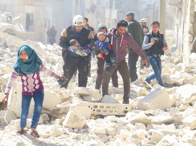 People and a civil defence personnel carry children at a damaged site after an air strike on rebel-held Idlib city, Syria March 19, 2017. REUTERS/Ammar Abdullah