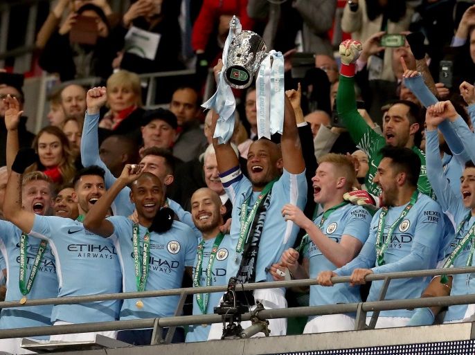 LONDON, ENGLAND - FEBRUARY 25: Vincent Kompany of Manchester City lifts the trophy after winning the Carabao Cup Final between Arsenal and Manchester City at Wembley Stadium on February 25, 2018 in London, England. (Photo by Catherine Ivill/Getty Images)