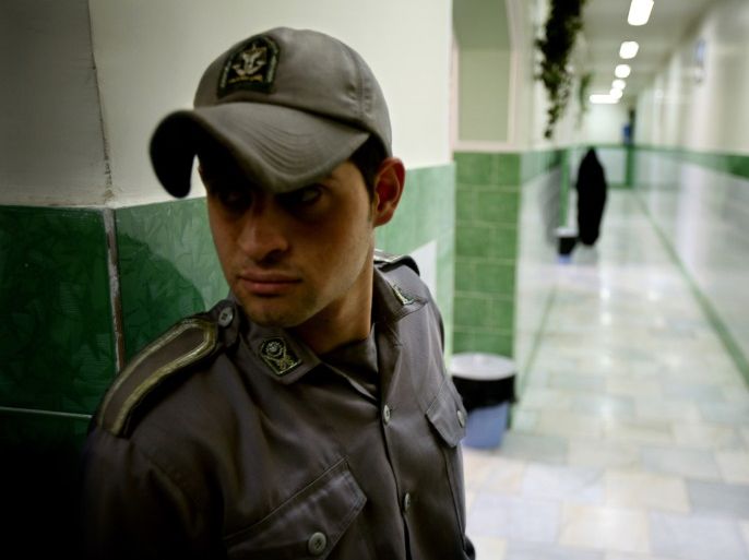 A prison guard stands along a corridor in Tehran's Evin prison June 13, 2006. Iranian police detained 70 people at a demonstration in favour of women's rights, the judiciary said on Tuesday, adding it was ready to review reports that the police had beaten some demonstrators.
