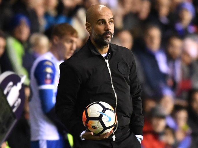 WIGAN, ENGLAND - FEBRUARY 19: Josep Guardiola, Manager of Manchester City retrieves the ball during the Emirates FA Cup Fifth Round match between Wigan Athletic and Manchester City at DW Stadium on February 19, 2018 in Wigan, England. (Photo by Michael Regan/Getty Images)