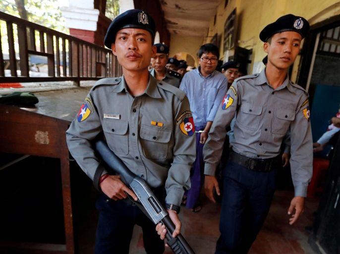 Detained Reuters journalist Wa Lone is escorted by police during a break at a court hearing in Yangon, Myanmar February 1, 2018. REUTERS/Jorge Silva TPX IMAGES OF THE DAY