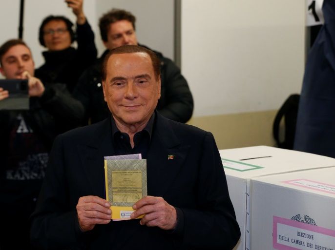 Forza Italia party leader Silvio Berlusconi casts his vote at a polling station in Milan, Italy March 4, 2018. REUTERS/Stefano Rellandini