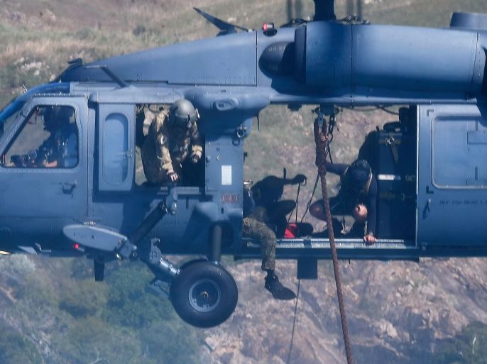 TOWNSVILLE, AUSTRALIA - JULY 01: A U.S military HH-60 Pave Hawk Helicopter is seen deploying rescue eqiupment over a simulated crash site during Exercise Angel Reign on July 1, 2016 in Townsville, Australia. Exercise Angel Reign is the largest Air Force led field exercise in Australia this year and is a bilateral Joint Personnel Recovery exercise which aims to practice search and rescue activities both at sea and on land. (Photo by Ian Hitchcock/Getty Images)