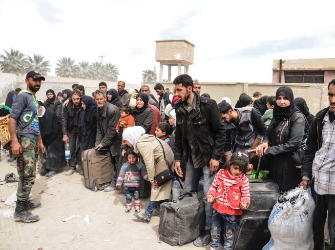 People are seen evacuated by Syrian forces from eastern Ghouta in Saqba, Syria, March 18, 2018. SANA/Handout via REUTERS ATTENTION EDITORS - THIS IMAGE HAS BEEN SUPPLIED BY A THIRD PARTY. REUTERS IS UNABLE TO INDEPENDENTLY VERIFY THIS IMAGE.