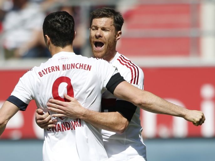 Football Soccer - FC Ingolstadt 04 v Bayern Munich - German Bundesliga - Audi Sportpark, Ingolstadt, Germany 07/05/16 Bayern Munich's Robert Lewandowski celebrates with Xabi Alonso after scoring a penalty. REUTERS/Michaela Rehle. DFL RULES TO LIMIT THE ONLINE USAGE DURING MATCH TIME TO 15 PICTURES PER GAME. IMAGE SEQUENCES TO SIMULATE VIDEO IS NOT ALLOWED AT ANY TIME. FOR FURTHER QUERIES PLEASE CONTACT DFL DIRECTLY AT + 49 69 650050