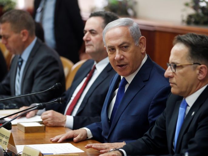 Israeli Prime Minister Benjamin Netanyahu sits next to Cabinet Secretary Tzachi Braverman (R) and Israeli Intelligence and Transportation Minister Israel Katz at the start of the weekly cabinet meeting at the Prime Minister's office in Jerusalem, April 11, 2018. REUTERS/Ronen Zvulun/Pool