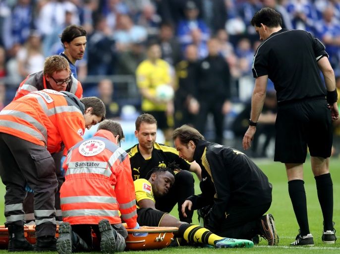 GELSENKIRCHEN, GERMANY - APRIL 15: Michy Batshuayi of Dortmund is treated after an injury during the Bundesliga match between FC Schalke 04 and Borussia Dortmund at Veltins-Arena on April 15, 2018 in Gelsenkirchen, Germany. (Photo by Christof Koepsel/Bongarts/Getty Images)