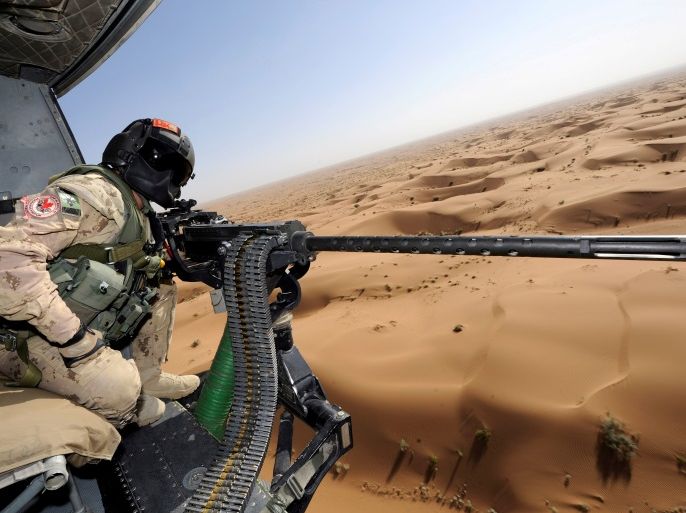 Canadian Forces door gunner Sergeant Chad Zopf leans out of a CH-146 Griffon helicopter during a training exercise in Kandahar district, Afghanistan June 18, 2011 in this handout photo obtained by Reuters March 19, 2018. Sgt Matthew McGregor/Canada Department of National Defence/Handout via REUTERS. ATTENTION EDITORS - THIS IMAGE WAS PROVIDED BY A THIRD PARTY.