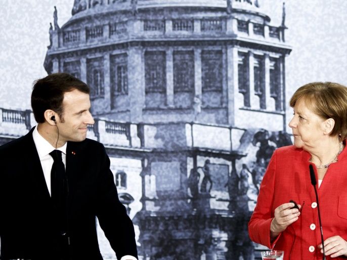 BERLIN, GERMANY - APRIL 19: German Chancellor Angela Merkel (R) and French President Emmanuel Macron (L) attend a pressconference following a visit in the Humboldt Forum construction site on April 19, 2018 in Berlin, Germany. The two leaders are meeting following Macron's delivery of an impassioned speech at the European Parliament on April 17, in which he urged reforms to further bind EU member states together and to counter authoritarianism. The Humboldt Forum, to be located in the reconstructed Berlin City Palace, in German called the Berliner Schloss, will draw on the collections of other Berlin museums and is to become the world's pre-eminent museum dedicated to non-Western art. (Photo by Carsten Koall/Getty Images)