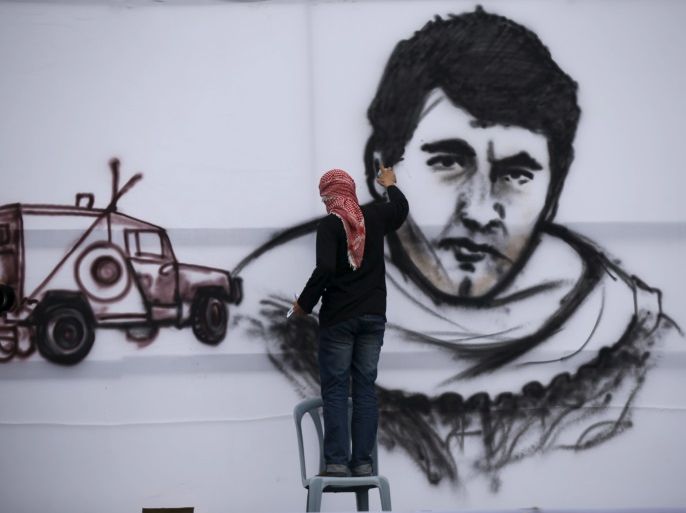 A Palestinian paints a picture of late Hamas bomb maker Yahya Ayyash during a Hamas rally in Khan Younis in the southern Gaza Strip January 7, 2016. The rally, organized by Hamas movement, was held to honor the families of dead Hamas militants, who Hamas's armed wing said participated in imprisoning Israeli soldier Gilad Shalit, organizers said. Shalt was abducted by militants in a cross-border raid in 2006, and was released in exchange for more than 1,000 Palestinians