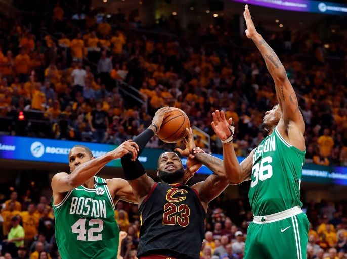May 19, 2018; Cleveland, OH, USA; Cleveland Cavaliers forward LeBron James (23) is fouled by Boston Celtics forward Al Horford (42) in front of guard Marcus Smart (36) during the first half in game three of the Eastern conference finals of the 2018 NBA Playoffs at Quicken Loans Arena. Mandatory Credit: Rick Osentoski-USA TODAY Sports