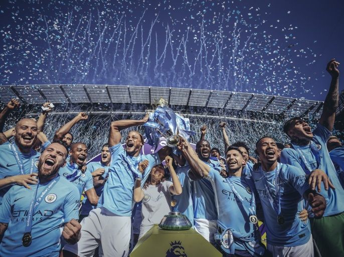 MANCHESTER, ENGLAND - MAY 06: [Editor's note - digital filters were used in the creation of this image] Vincent Kompany and Sergio Aguero of Manchester City lift the Premier League trophy during the Premier League match between Manchester City and Huddersfield Town at Etihad Stadium on May 6, 2018 in Manchester, England. (Photo by Michael Regan/Getty Images)