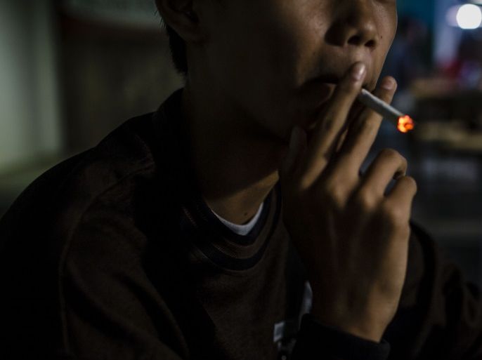 YOGYAKARTA, INDONESIA - MARCH 07: Anggit (14), smokes at a coffee shop with his friends on March 7, 2017 in Yogyakarta, Indonesia. Smoking among Indonesian children has reportedly been on the rise with an estimated 20 million child smokers under the age of 10, according to reports. The Indonesian government recently implemented bans on smoking in public places and prohibitions on cigarette ads to reduce the number of people lighting up although smoking has been ingrained in Indonesian culture with over 70 percent of the country's men smoking. Health activists describe Indonesia as a sanctuary for big tobacco companies and that underage smoking in Indonesia has become a problem that transcends class as it rises in popularity among the poor. Many locals make their livelihood through tobacco farms, which produce locally made cigarettes called kreteks, a blend of tobacco and cloves, and surrounded by cigarettes from an early age. (Photo by Ulet Ifansasti/Getty Images)