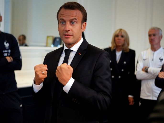 French President Emmanuel Macron speaks to the French national soccer team players, as goalkeeper Hugo Lloris (L), his wife, Brigitte Macron (2ndR) and head coach Didier Deschamps (R) look on during a meeting at France's training camp in Clairefontaine, near Paris, France, June 5, 2018 prior to the national team's participation to the 2018 FIFA World Cup Russia. Francois Mori/Pool via Reuters