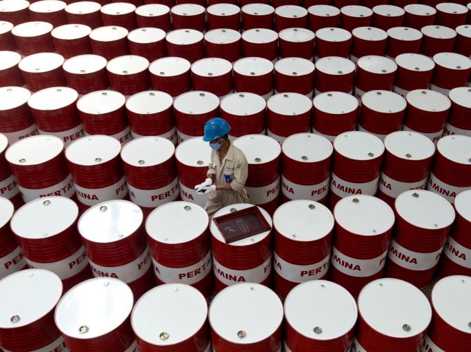 FILE PHOTO: A worker prepares to label barrels of lubricant oil at the state oil company Pertamina's lubricant production facility in Cilacap, Central Java, Indonesia November 6, 2017 in this photo taken by Antara Foto. Antara Foto/Rosa Panggabean/File Photo via REUTERS ATTENTION EDITORS - THIS IMAGE WAS PROVIDED BY A THIRD PARTY. MANDATORY CREDIT. INDONESIA OUT.