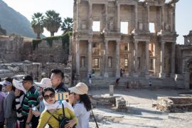 IZMIR, TURKEY - SEPTEMBER 18: A member of an asian tourist group takes a selfie in front of the ruins of the Library of Celsus in the ancient city of Ephesus on September 18, 2017 in Izmir, Turkey. The ancient city of Ephesus continues to draw visitors as one of Turkey's top tourist attractions. Ephesus was an Ancient Greek city. Excavations of the site have revealed grand monuments from the Roman Imperial period including the remains of the famous Temple of Artemis, the Great Theatre and the Library of Celsus. (Photo by Chris McGrath/Getty Images)
