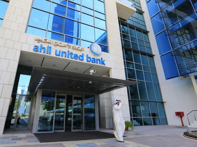 A customer walks out from the main entrance to Ahli United Bank's headquarters in Manama October 30, 2013. Ahli United Bank, Bahrain's largest lender by market value, reported an 8.6 percent rise in its third-quarter net profit on Wednesday, on the back of higher net interest and fee income. REUTERS/Hamad I Mohammed (BAHRAIN - Tags: BUSINESS)