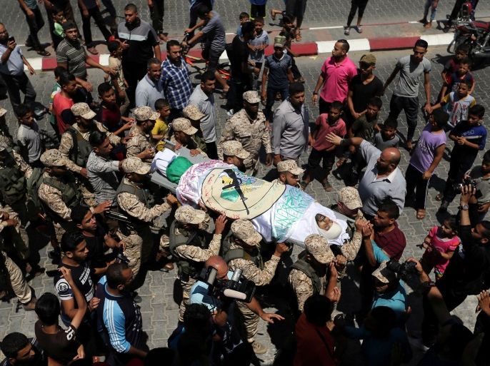 ATTENTION EDITORS - VISUAL COVERAGE OF SCENES OF INJURY OR DEATH Palestinian Hamas militants carry the body of their comrade Abed Alkareem Redwan, who was killed in an Israeli air strike, during his funeral in Rafah in the southern Gaza Strip July 20, 2018. REUTERS/Ibraheem Abu Mustafa TEMPLATE OUT.