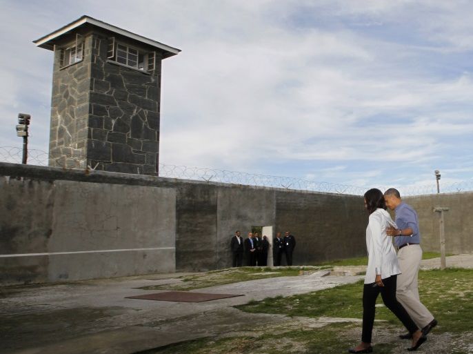 U.S. President Barack Obama tours Robben Island with first lady Michelle Obama, near Cape Town, June 30, 2013. Under apartheid, Nelson Mandela spent several decades as a political prisoner on Robben Island. REUTERS/Jason Reed (SOUTH AFRICA - Tags: POLITICS)