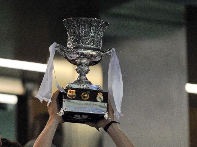 MADRID, SPAIN - AUGUST 29: Luka Modric of Real Madrid CF holds up the trophy after defeating FC Barcelona during the Supercopa second leg match betwen Real Madrid and FC Barcelona at Estadio Santiago Bernabeu on August 29, 2012 in Madrid, Spain. (Photo by David Ramos/Getty Images)