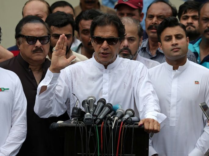 Cricket star-turned-politician Imran Khan, chairman of Pakistan Tehreek-e-Insaf (PTI), speaks to members of media after casting his vote at a polling station during the general election in Islamabad, Pakistan, July 25, 2018. REUTERS/Athit Perawongmetha
