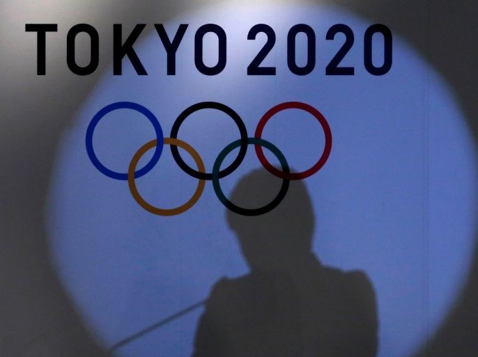 A shadow of of Tokyo governor Yuriko Koike is seen on the logo of Tokyo 2020 Olympic games during the Olympic and Paralympic flag-raising ceremony at Tokyo Metropolitan Government Building in Tokyo, Japan, September 21, 2016. REUTERS/Toru Hanai