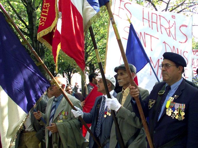 Harkis, Algerians who fought on the French side during the Algerian war, wear their military medals and hold French flags during a demonstration near the Invalides September 15. Some 500 Harkis and their descendants protested against their economic situation with unemployment running three times the national average.JES/