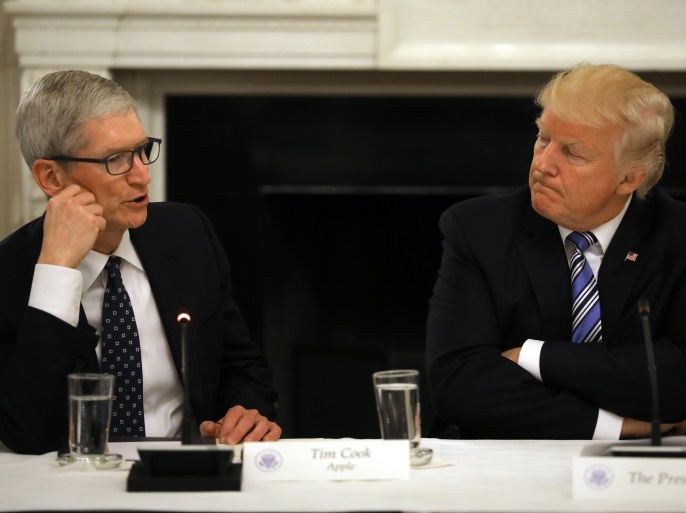 U.S. President Donald Trump listens as Tim Cook, CEO of Apple speaks during an American Technology Council roundtable at the White House in Washington, U.S., June 19, 2017. REUTERS/Carlos Barria