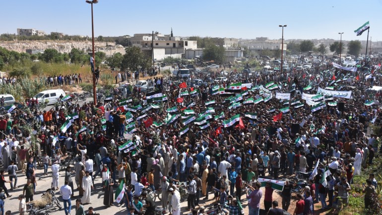 Anti-regime protest in Idlib- - IDLIB, SYRIA - SEPTEMBER 14 : Syrians gathering after Friday prayer in the town of Marratinuman of Idlib hold an anti-regime protest against the regime forces' possible attacks on Idlib, Syria on September 14, 2018.