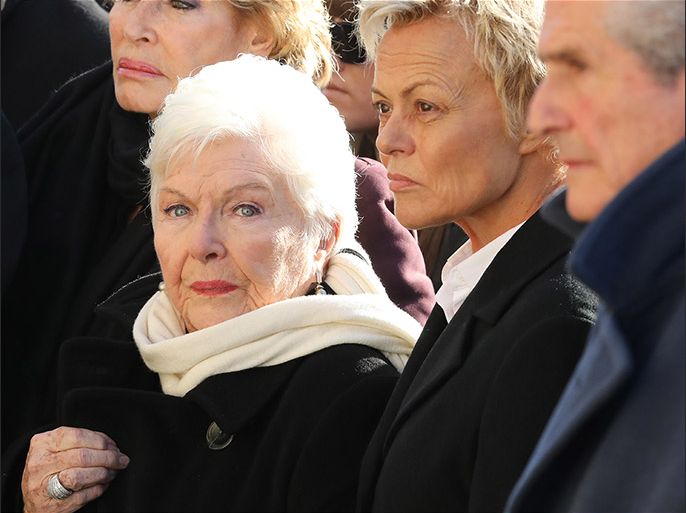 epa06379169 French singer Line Renaud (2nd-L), French humorist Muriel Robin (2nd-R), and French film director Claude Lellouch (1st-R) stand outside the La Madeleine Church prior to the funeral ceremony in Paris, France, 09 December 2017. Johnny Hallyday, France's biggest rock star, has died of cancer on 06 December. He was 74. EPA-EFE/LUDOVIC MARIN / POOL MAXPPP OUT