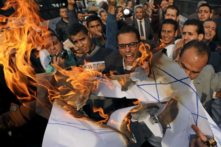 Protestors shout slogans and burn an Israeli flag during an anti-Trump anti-Israel protest at Lawyers Syndicate, in Cairo, Egypt December 10, 2017. REUTERS/Mohamed Abd El Ghany