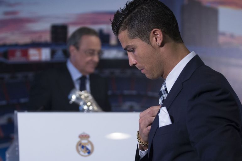 MADRID, SPAIN - OCTOBER 02: Cristiano Ronaldo walks to the tribune ahead president Florentino Perez before receiving his trophy as all-time top scorer of Real Madrid CF at Honour box-seat of Santiago Bernabeu Stadium on October 2, 2015 in Madrid, Spain. Portuguese palyer Cristiano Ronaldo overtook on his last UEFA Champions League match against Malmo FF Raul's record as Real Madrid all-time top scorer. (Photo by Gonzalo Arroyo Moreno/Getty Images)