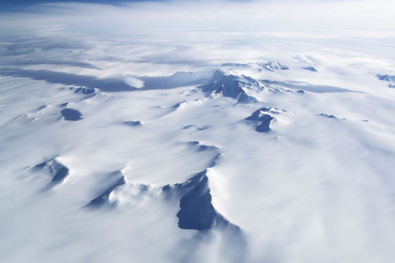 UNSPECIFIED, ANTARCTICA - NOVEMBER 04: Mountains and land ice are seen from NASA's Operation IceBridge research aircraft in the Antarctic Peninsula region, on November 4, 2017, above Antarctica. NASA's Operation IceBridge has been studying how polar ice has evolved over the past nine years and is currently flying a set of nine-hour research flights over West Antarctica to monitor ice loss aboard a retrofitted 1966 Lockheed P-3 aircraft. According to NASA, the current