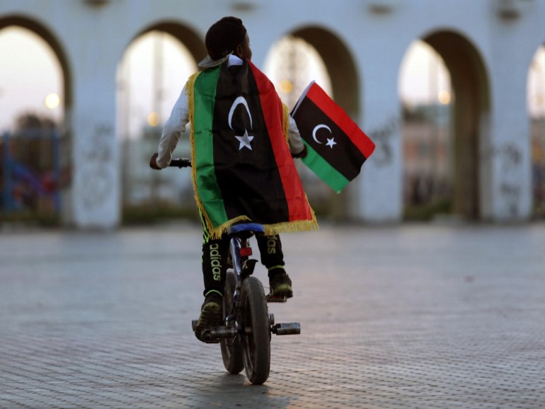 A boy wearing a Libyan flag takes part in a celebration marking the sixth anniversary of the Libyan revolution, in Benghazi, Libya February 17, 2017. REUTERS/Esam Omran Al-Fetori TPX IMAGES OF THE DAY