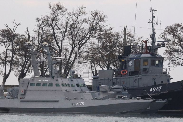 Seized Ukrainian ships, small armoured artillery ships and a tug boat, are seen anchored in a port of Kerch, Crimea November 26, 2018. REUTERS/Pavel Rebrov