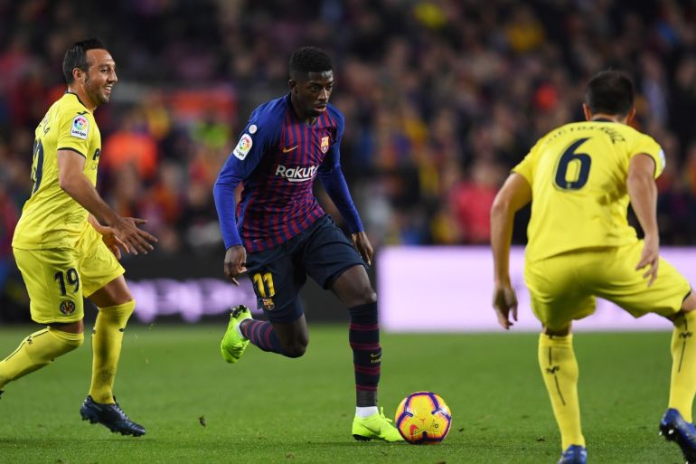 BARCELONA, SPAIN - DECEMBER 02: Ousmane Dembele of Barcelona takes on Santi Cazorla (L) and Victor Ruiz of Villareal (R) during the La Liga match between FC Barcelona and Villarreal CF at Camp Nou on December 2, 2018 in Barcelona, Spain. (Photo by David Ramos/Getty Images)