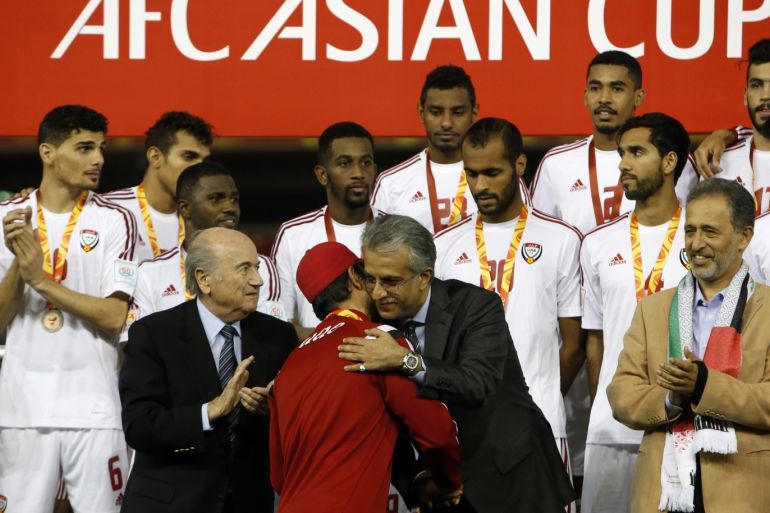 UAE's coach Mahdi Ali Hassan (C) is congratulated as his players look on on the podium following their Asian Cup third-place playoff soccer match win over Iraq at the Newcastle Stadium in Newcastle January 30, 2015. REUTERS/Edgar Su (AUSTRALIA - Tags: SOCCER SPORT)