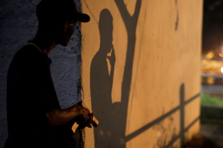 A Brazilian drug gang member poses with a gun in a slum in Rio de Janeiro, Brazil March 17, 2018. Picture taken March 17, 2018. REUTERS/Alan Lima