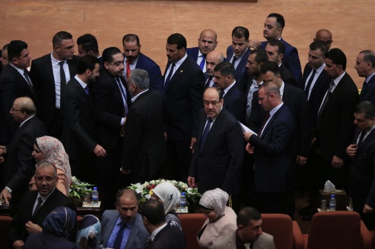 New Iraqi parliament convenes for 1st time since polls- - BAGHDAD, IRAQ - SEPTEMBER 03: Former Prime Minister Nouri al-Maliki (C), leader of State of Law coalition attends the opening session of New Iraqi parliament at the Parliament Building on September 03, 2018 in Baghdad, Iraq. The newly-seated Iraqi Parliament convened on Monday for the first time since the May 12 parliamentary elections.