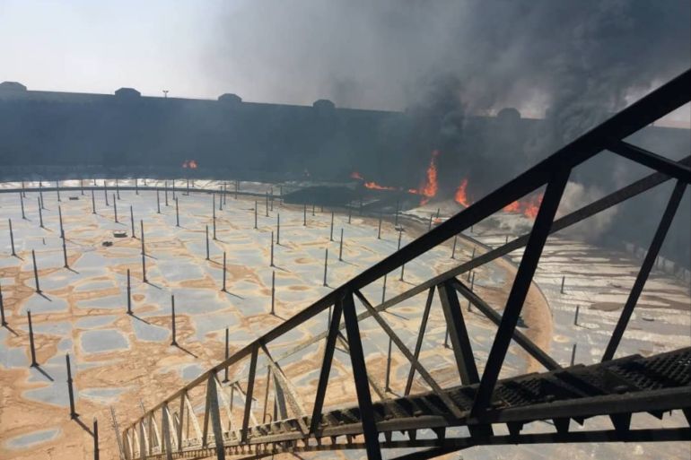 Smoke and flame rise from an oil storage tank that was set on fire amid fighting between rival factions at Ras Lanuf terminal, Libya in this handout picture released on June 16, 2018. The National Oil Corporation/ Handout via Reuters ATTENTION EDITORS - THIS PICTURE WAS PROVIDED BY A THIRD PARTY. REUTERS IS UNABLE TO INDEPENDENTLY VERIFY THIS IMAGE.