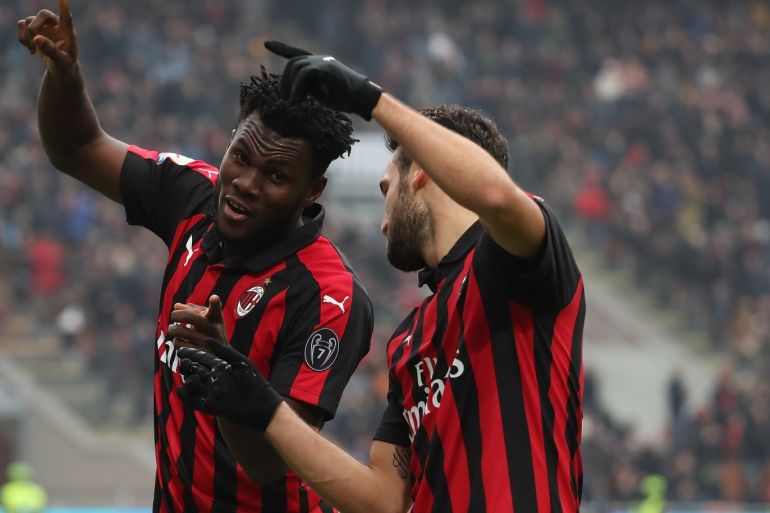 MILAN, ITALY - DECEMBER 02: Franck Kessie (L) of AC Milan celebrates his goal with his team-mate Hakan Calhanoglu (R) during the Serie A match between AC Milan and Parma Calcio at Stadio Giuseppe Meazza on December 2, 2018 in Milan, Italy. (Photo by Marco Luzzani/Getty Images)