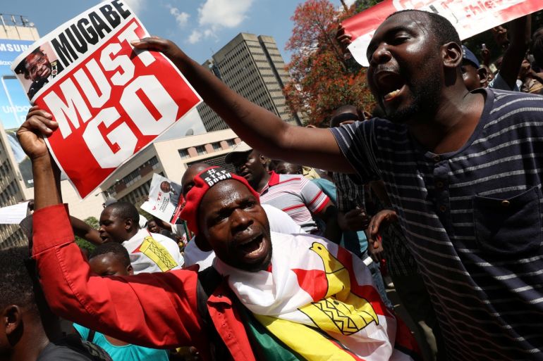 Protesters calling for Zimbabwean President Robert Mugabe to resign demonstrate outside parliament in Harare, Zimbabwe, November 21, 2017. REUTERS/Mike Hutchings